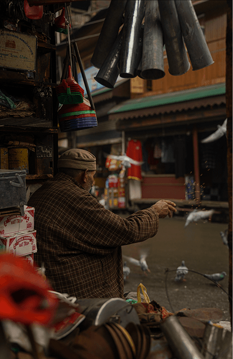 Market vendor with hanging items